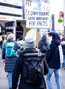 marchers with sign about facts